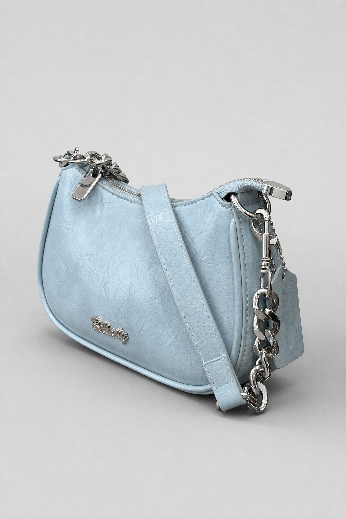 Light blue handbag with a chain detail on a gray background