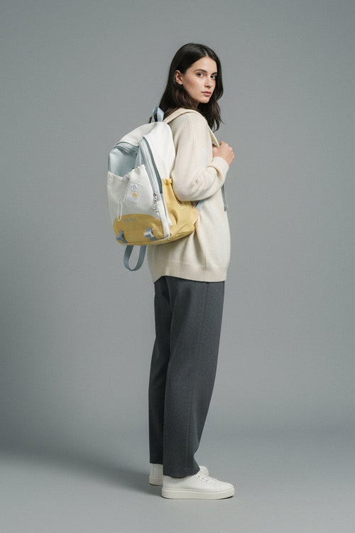 White and yellow backpack on a light gray background