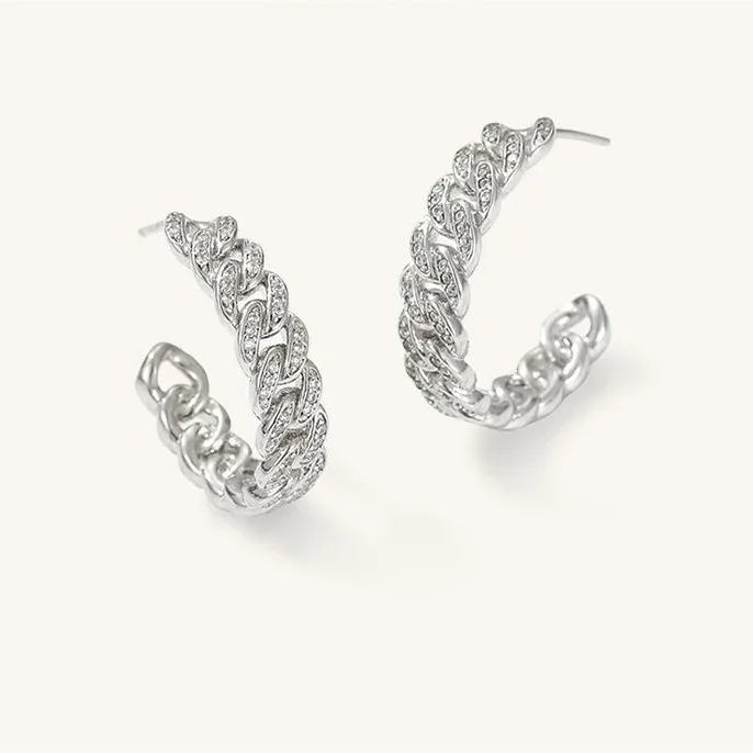 Pair of silver hoop earrings on a white background